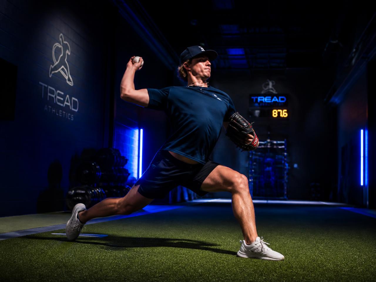 Baseball pitcher throwing on turf in a private performance facility